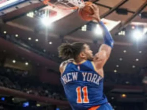 An NBA basketball player driving to the hoop during a live game in New York City.